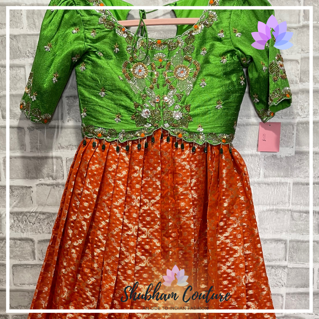 Beautiful organza zari lehanga in bright orange paired with parrot green blouse