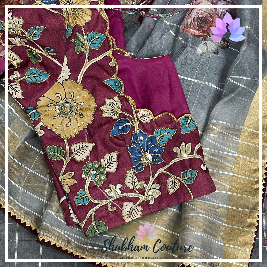 Floral grey organza saree with contrast kalamkari blouse in wine